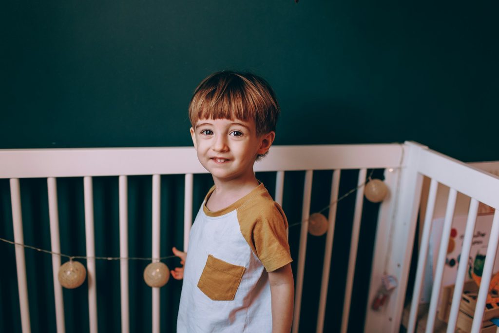A professional children photographer capturing a child for a memorable family photo.